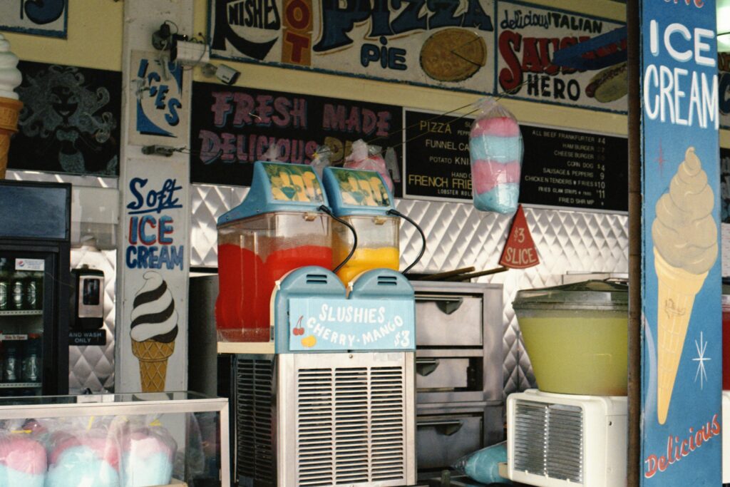 A modern cotton candy machine spinning pink cotton candy at a party setup